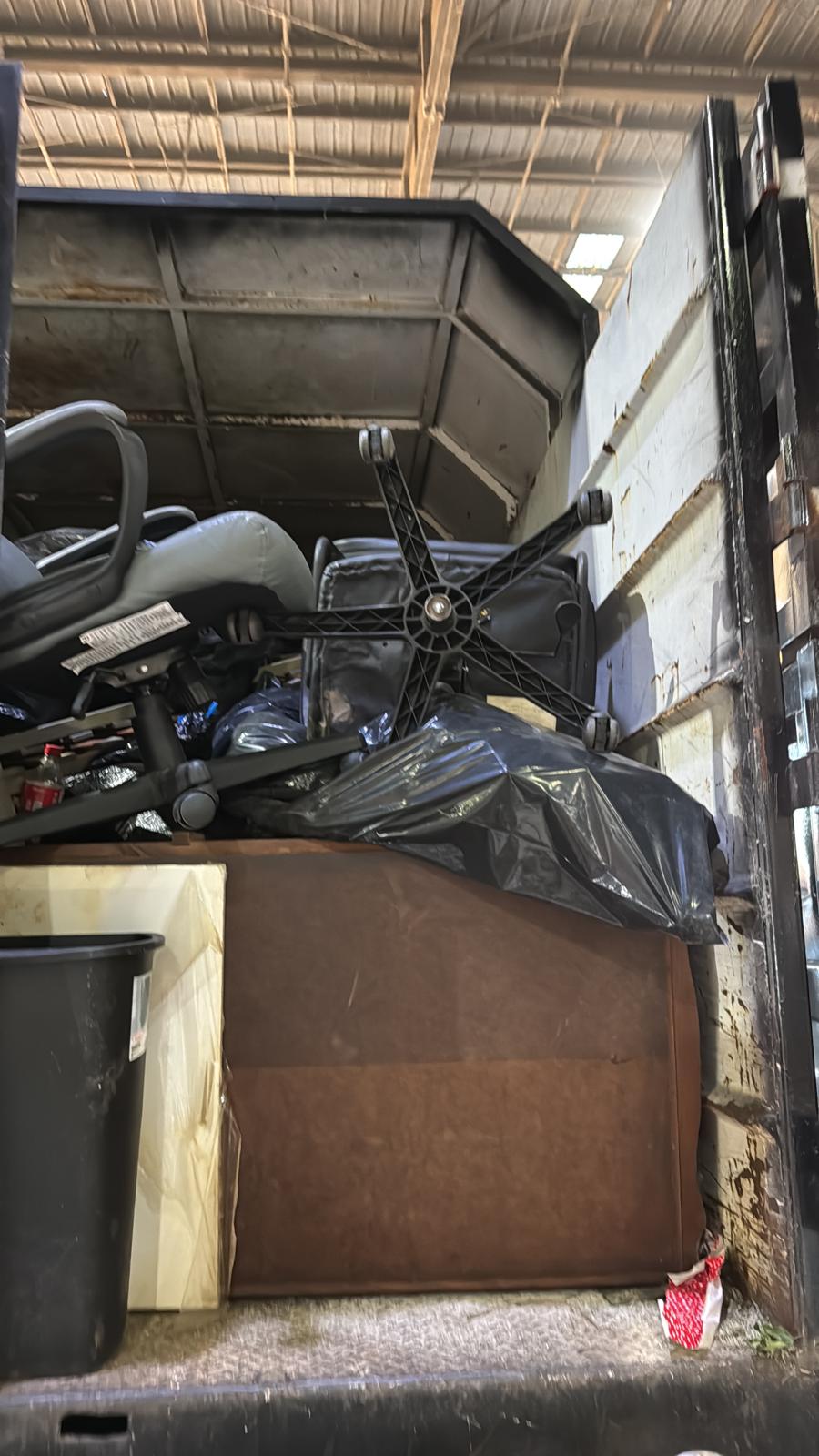 Office furniture and chairs loaded for removal